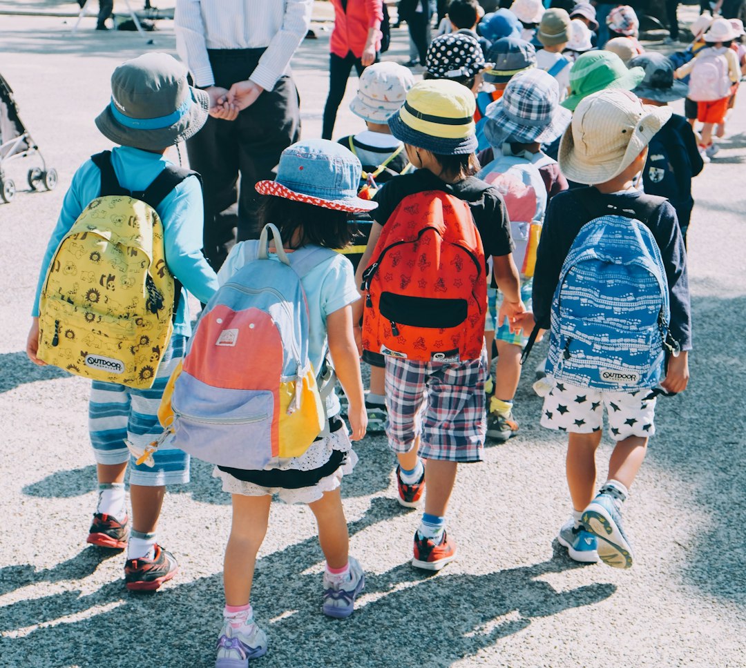 Young schoolchildren wearing backpacks as they walk together