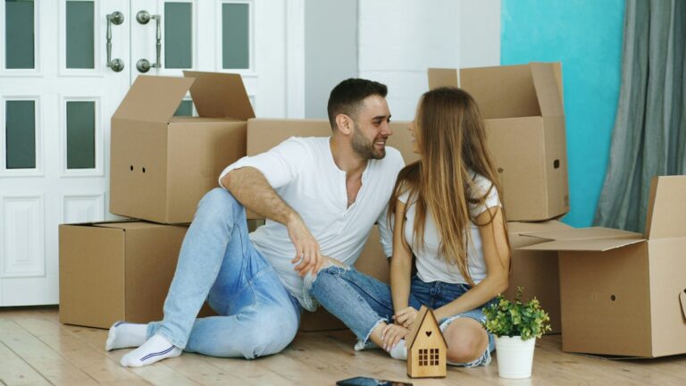 Couple moving into a new home with cardboard boxes