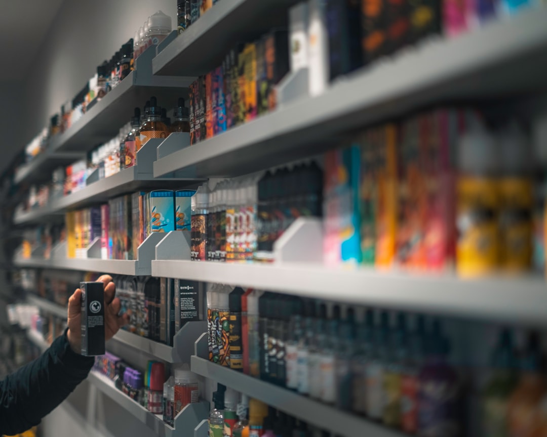 Adult customer browsing vaping products in a retail shop