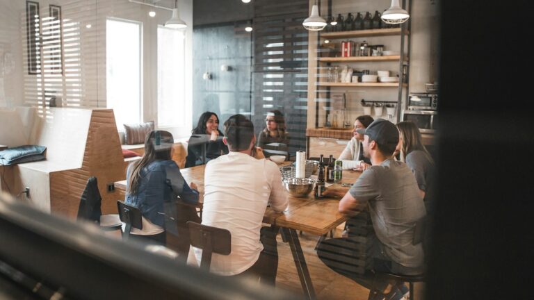 Employees discussing workplace information around a table