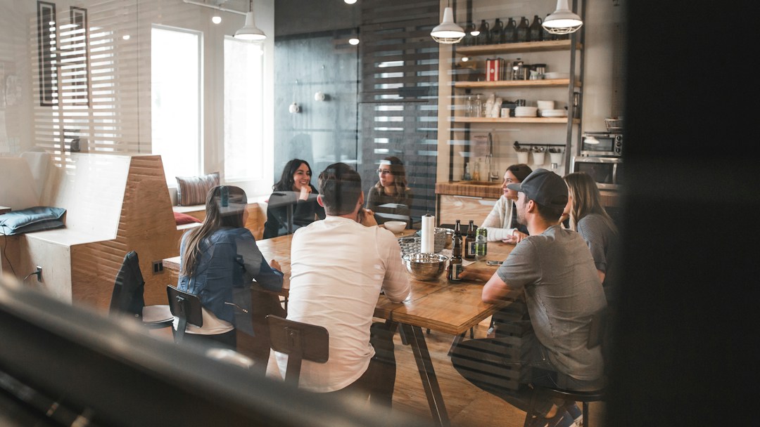 Employees discussing workplace information around a table