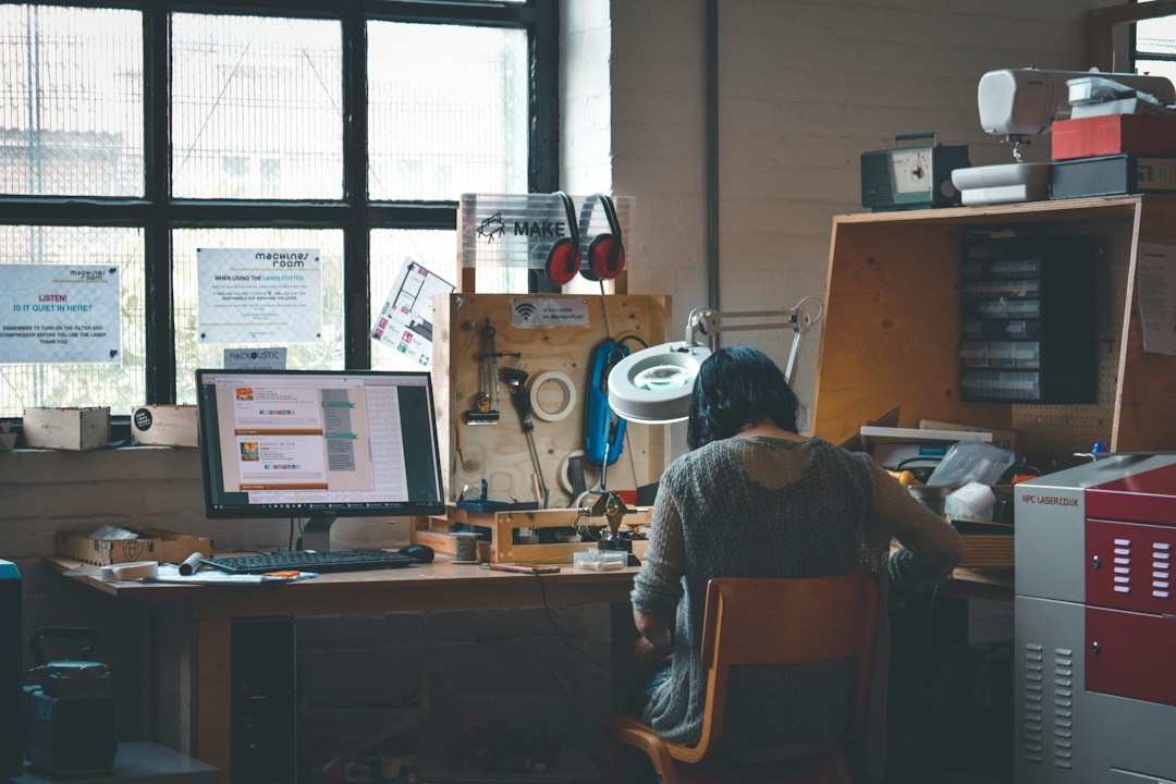 Person reviewing documents at a desk in a workplace