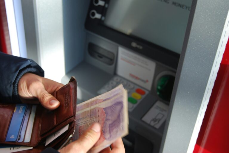 Person withdrawing money from a UK cash machine