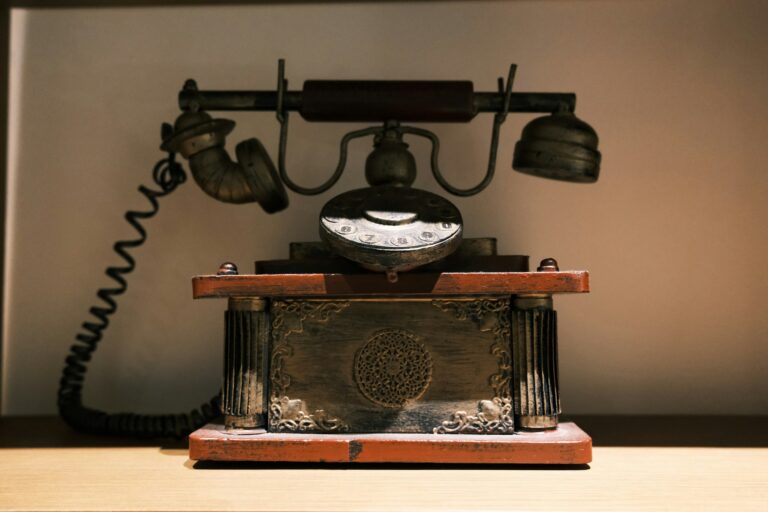 An old-fashioned corded telephone on a wooden table