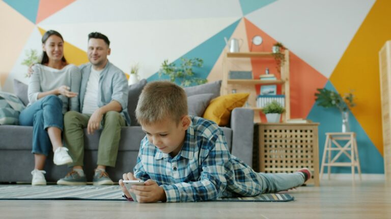 Child using a smartphone while parents watch at home