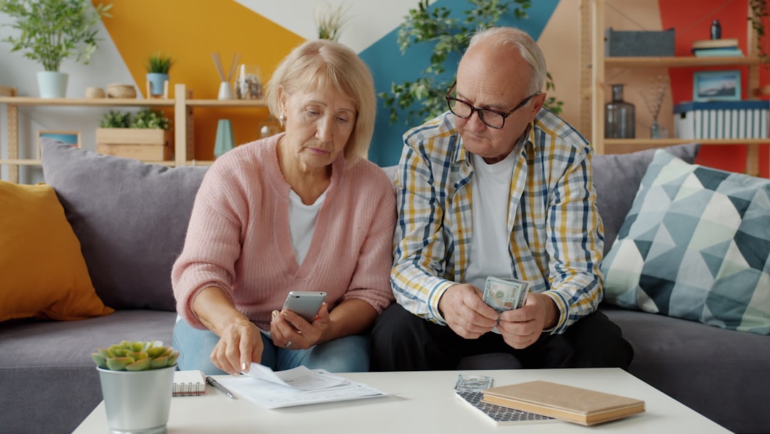 Retired couple reviewing financial documents and household finances at home