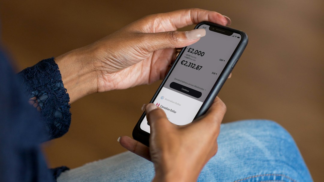 Person Holding a Smartphone While Reviewing an Online Payment
